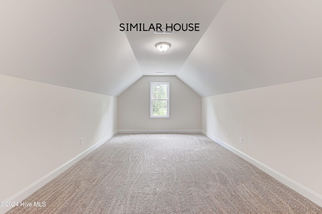 bonus room with carpet and vaulted ceiling