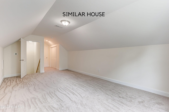 bonus room featuring light carpet and lofted ceiling