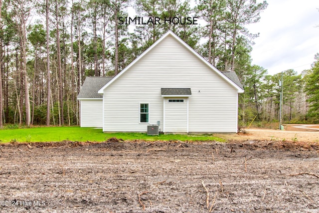 view of property exterior with a yard and central air condition unit