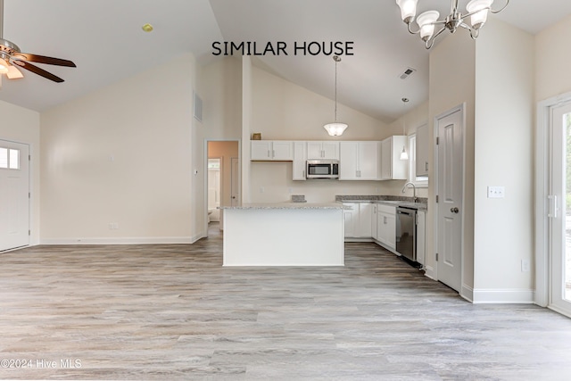 kitchen with a healthy amount of sunlight, white cabinetry, a center island, and stainless steel appliances