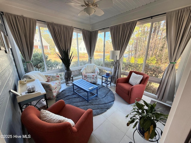 sunroom featuring ceiling fan and plenty of natural light