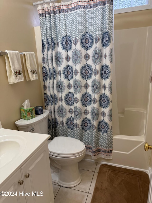 full bathroom with shower / bathtub combination with curtain, tile patterned flooring, vanity, and toilet