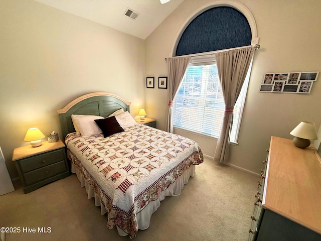 carpeted bedroom with vaulted ceiling