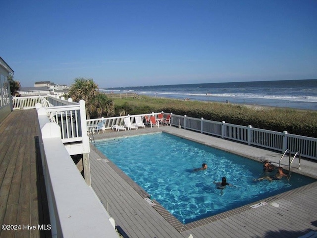 view of pool with a deck with water view