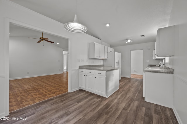 kitchen with white cabinetry, ceiling fan, dark hardwood / wood-style flooring, decorative light fixtures, and vaulted ceiling