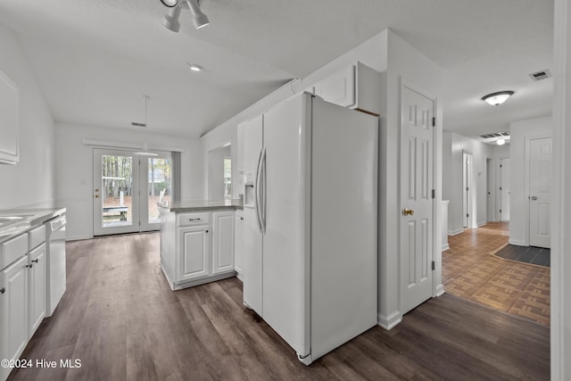 kitchen featuring white appliances, dark hardwood / wood-style floors, and white cabinetry