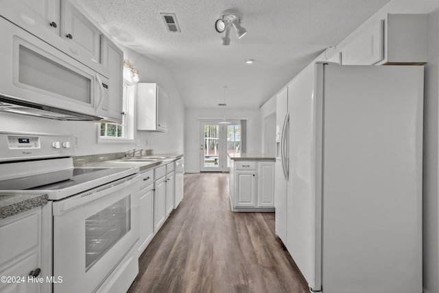 kitchen featuring white cabinetry, dark wood-type flooring, hanging light fixtures, a textured ceiling, and white appliances