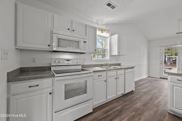 kitchen with white cabinetry, sink, dark hardwood / wood-style floors, vaulted ceiling, and white appliances