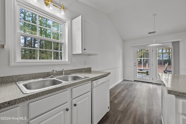 kitchen featuring vaulted ceiling, white dishwasher, white cabinetry, and a wealth of natural light