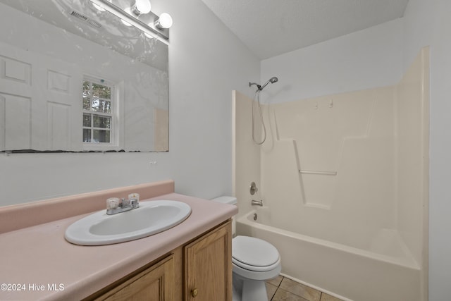 full bathroom with vanity,  shower combination, tile patterned floors, toilet, and a textured ceiling