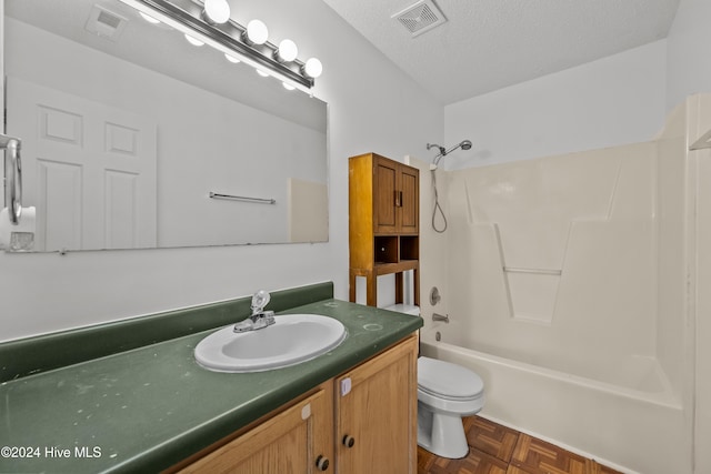 full bathroom featuring parquet floors, vanity, a textured ceiling, washtub / shower combination, and toilet