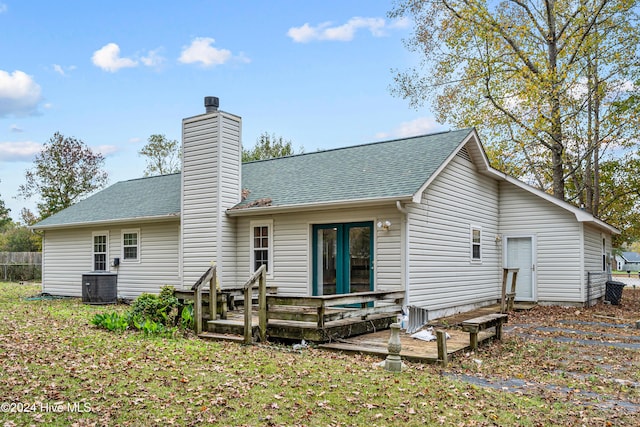 rear view of property with a wooden deck and central AC unit