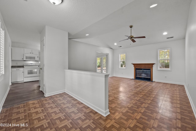 unfurnished living room featuring a textured ceiling, ceiling fan, and lofted ceiling