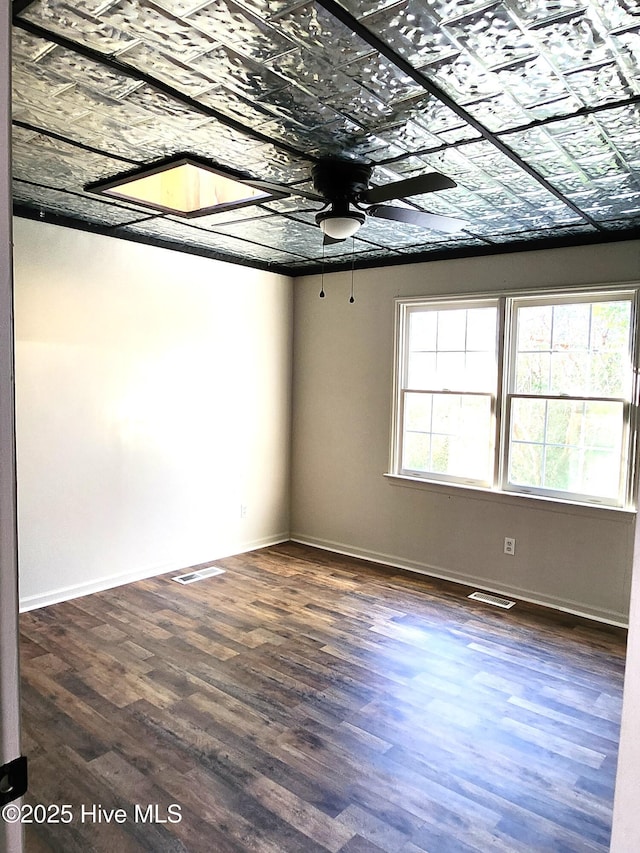 spare room featuring ceiling fan and dark hardwood / wood-style flooring