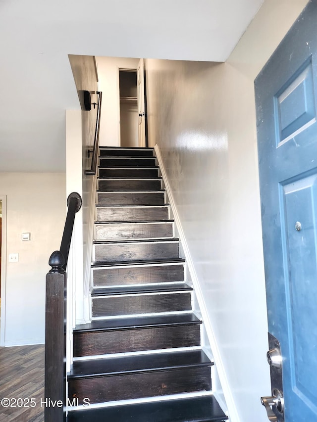 stairs with wood-type flooring