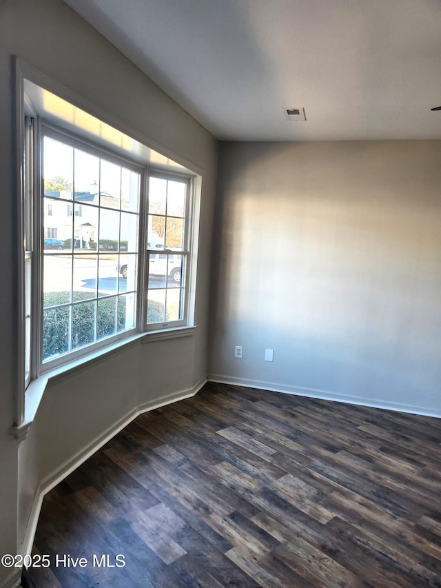 empty room featuring dark wood-type flooring