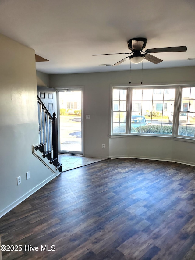 interior space with dark hardwood / wood-style floors and ceiling fan