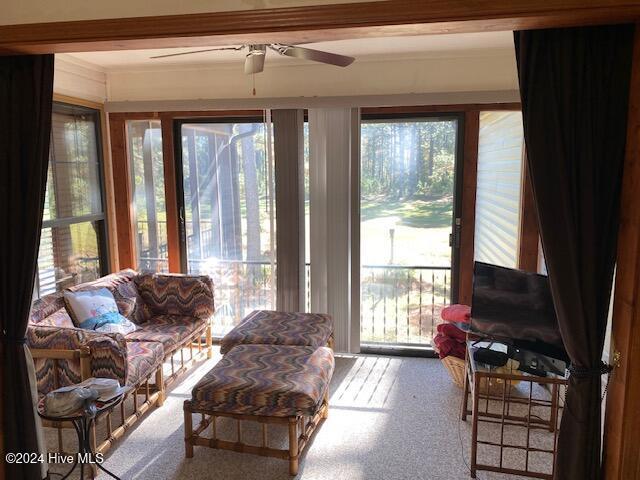 sunroom / solarium featuring ceiling fan