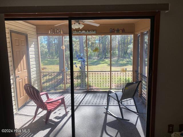 sunroom with a wealth of natural light and ceiling fan