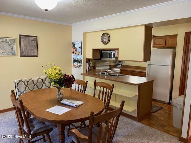 202 Country Club Villa Dr # 2, Shallotte, NC 28470 - dining space featuring ornamental molding