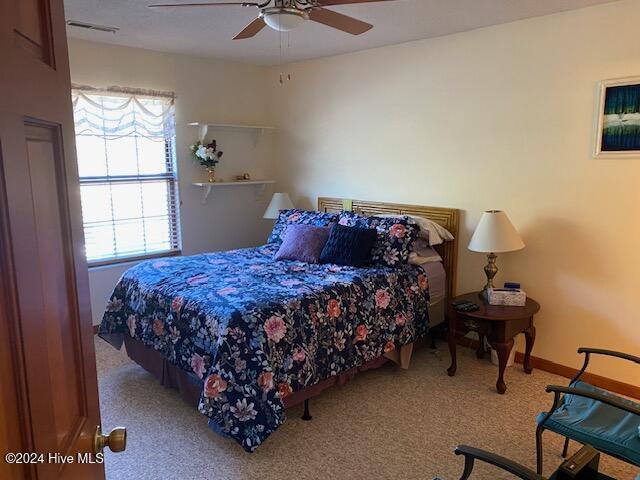 carpeted bedroom with ceiling fan