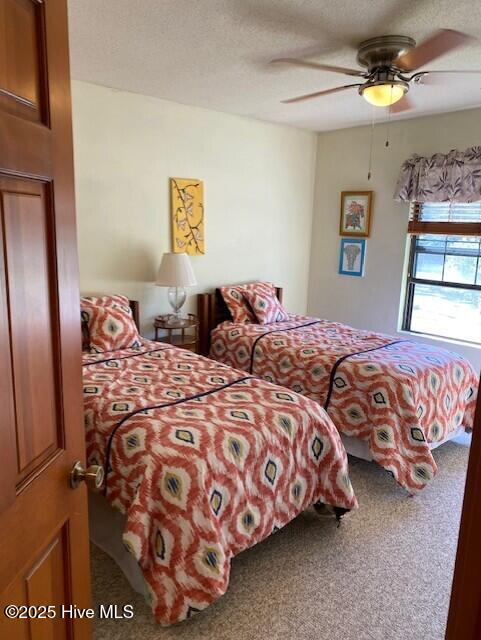 202 Country Club Villa Dr # 2, Shallotte, NC 28470 - carpeted living room with ornamental molding and a ceiling fan
