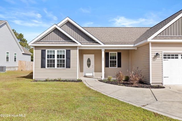 view of front of house with a porch, a garage, central air condition unit, and a front lawn