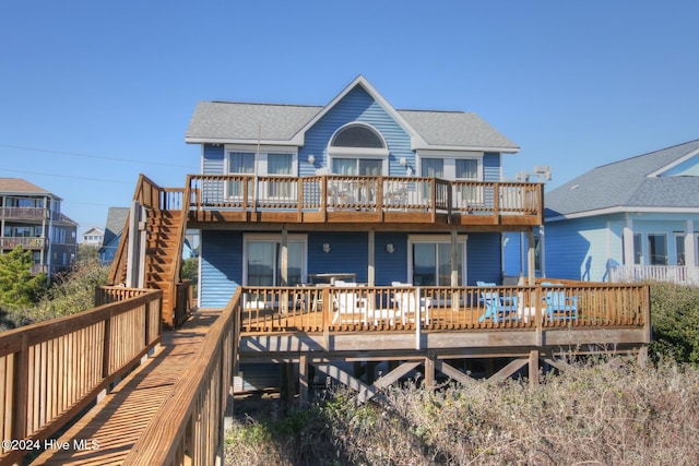 back of house featuring a deck