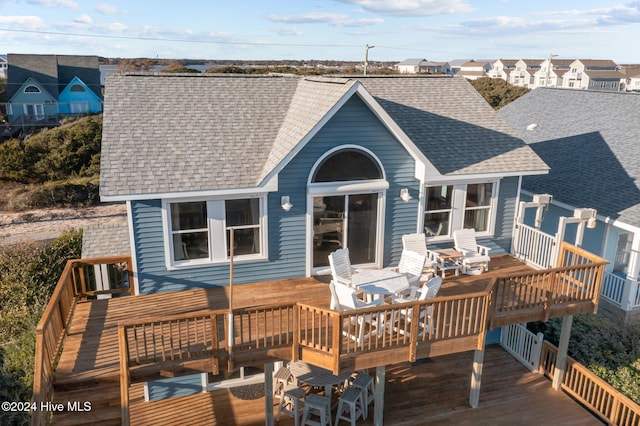 back of house featuring a wooden deck