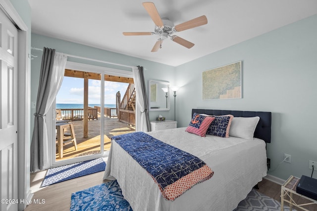 bedroom with a water view, ceiling fan, access to exterior, wood-type flooring, and a closet