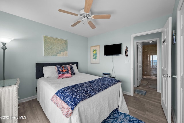 bedroom featuring ensuite bath, ceiling fan, and hardwood / wood-style floors