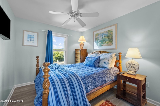 bedroom with ceiling fan and dark wood-type flooring