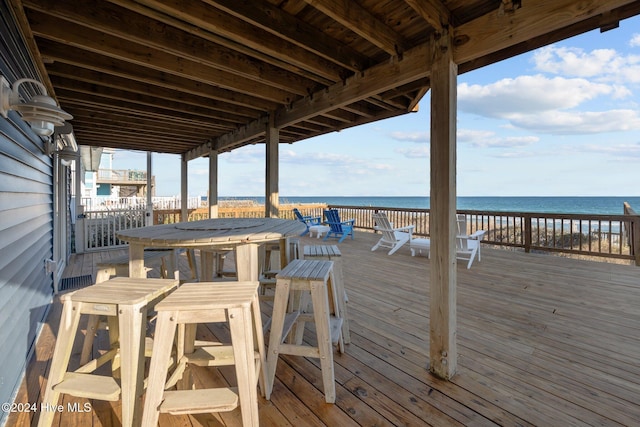 wooden terrace featuring a water view