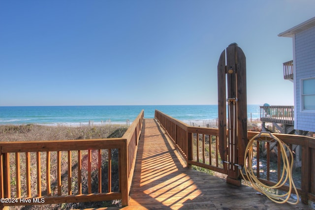 view of community with a water view and a beach view