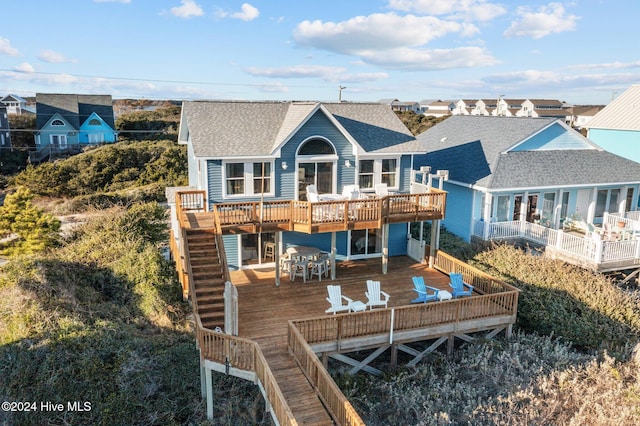 back of property with a wooden deck