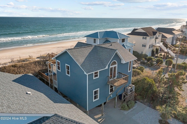 drone / aerial view with a water view and a view of the beach