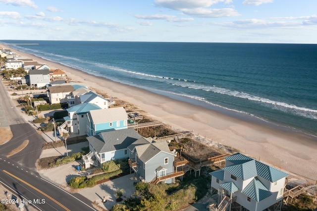 bird's eye view featuring a view of the beach and a water view