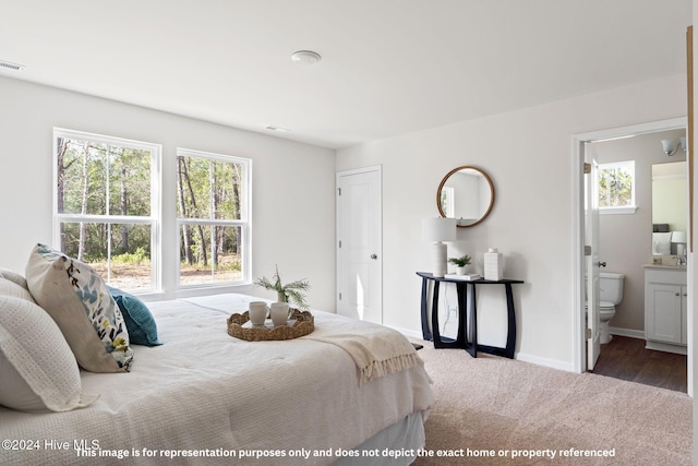 carpeted bedroom with connected bathroom