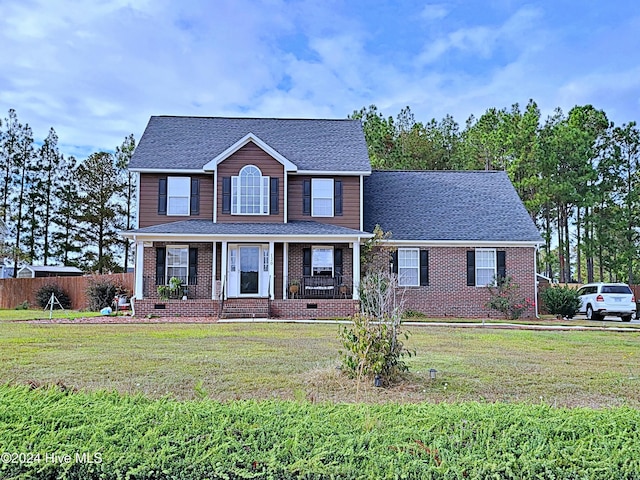 view of front facade with covered porch and a front yard