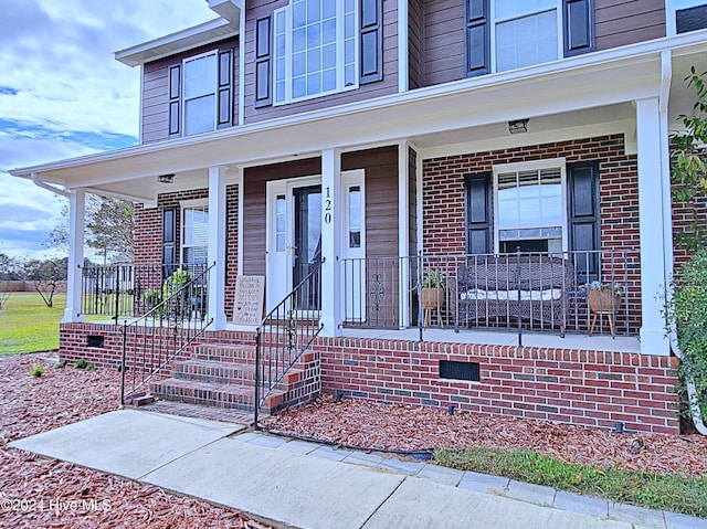 entrance to property featuring a porch