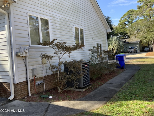 view of side of home with central AC