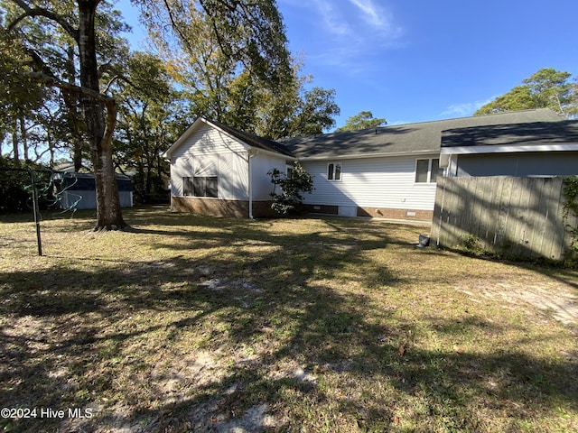 view of side of home with a yard