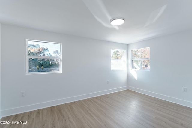 unfurnished room with plenty of natural light and light hardwood / wood-style floors