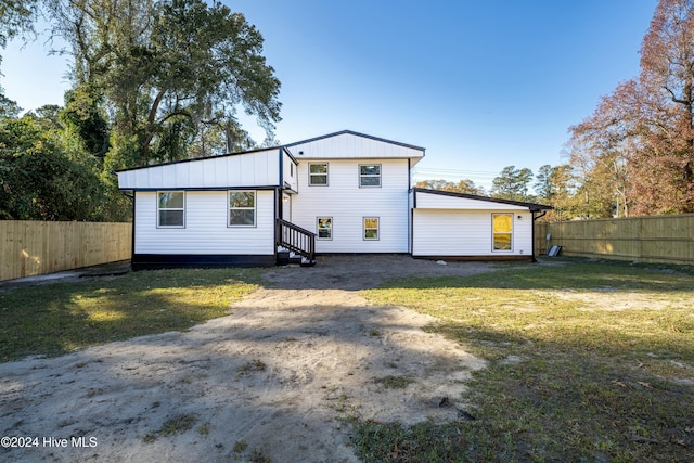 rear view of property with a yard