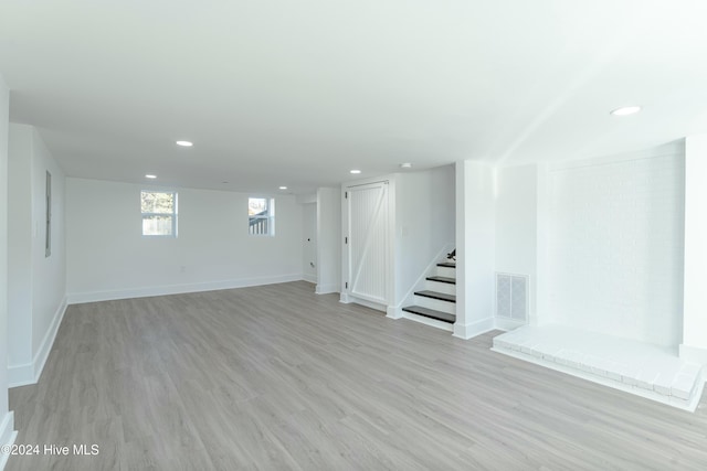 basement featuring light hardwood / wood-style flooring