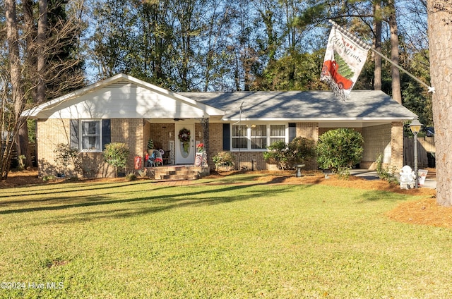 ranch-style home with a front yard and a carport