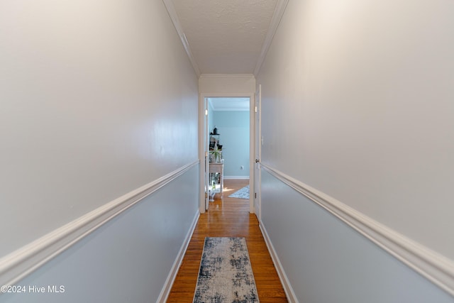 hall with crown molding and hardwood / wood-style floors