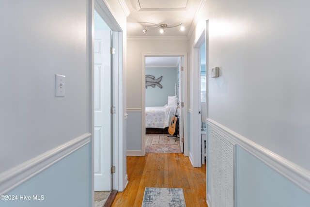 corridor featuring light hardwood / wood-style floors and ornamental molding