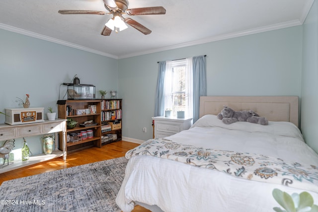 bedroom with ceiling fan, ornamental molding, and light hardwood / wood-style flooring