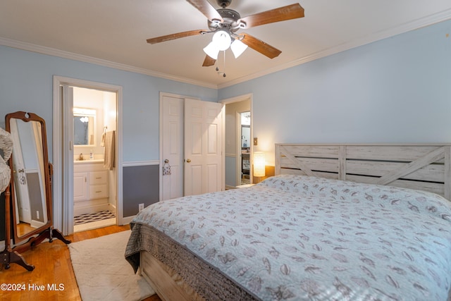 bedroom featuring ensuite bath, ceiling fan, sink, light hardwood / wood-style flooring, and ornamental molding